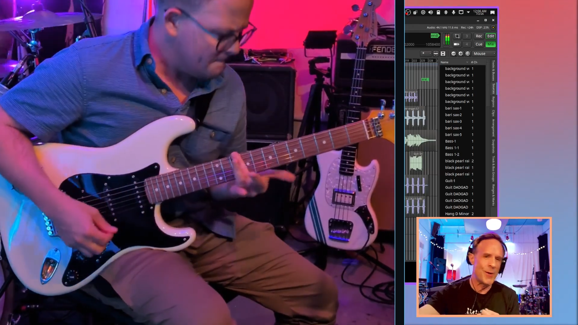 screenshot of person playing guitar in the studio
