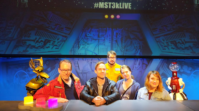 Tom Ray sitting at a table with the cast of MST3K