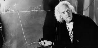 picture of man drawing lines on chalkboard